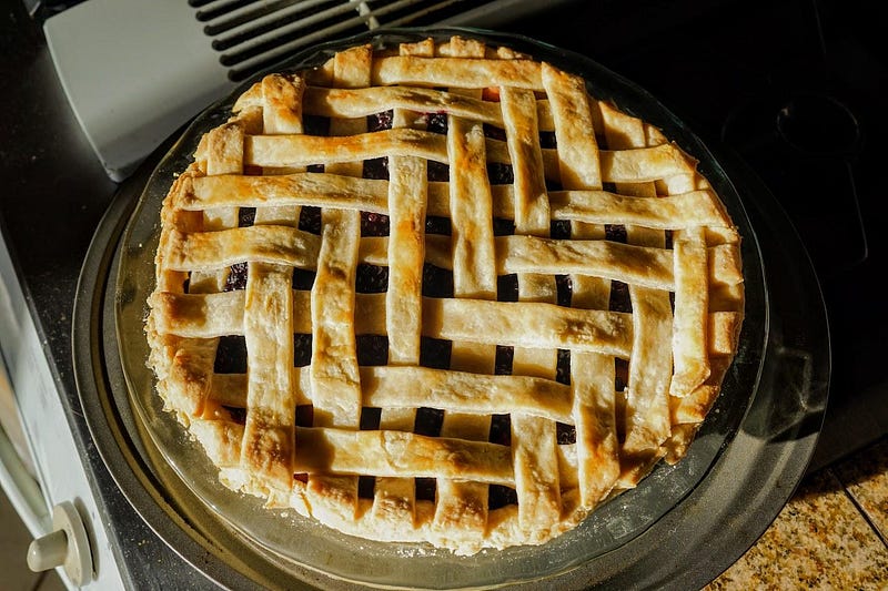 Oven with pie cooling on the counter.